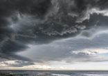 Approaching storm cloud with rain over the sea