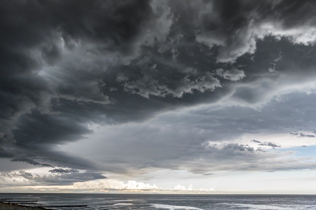 Approaching storm cloud with rain over the sea