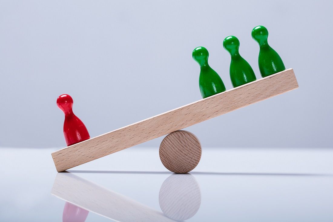 Pawns Figures On Wooden Seesaw