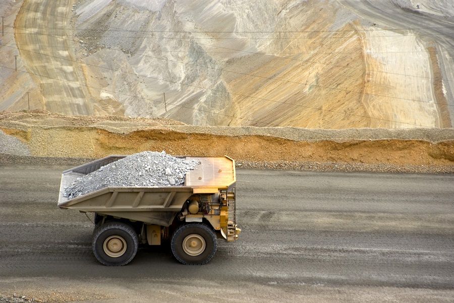 Yellow large dump truck in Utah copper mine seen from above