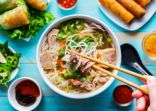 eating colorful vietnamese pho bo with chopsticks