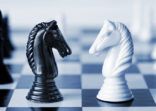Black versus white chess knights on a board