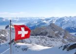 switzerland flagg over swiss alps