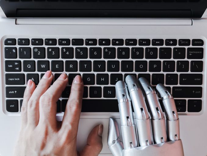 Robot hands and fingers point to laptop button advisor chatbot robotic artificial intelligence concept