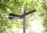 Blank metal signpost on green background