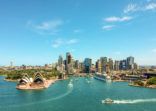 Stunning wide angle aerial drone view of the Sydney Harbour with the Opera House, a cruise ship and many skyscrapers in the background. Taken near the suburb of Kirribilli. New South Wales, Australia.