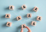 Building a strong team, Wooden blocks with people icon on pink background, Human resources and management concept.