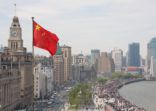 The Bund in Shanghai, China, with Chinese flag