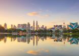 Panoramic view of Kuala Lumpur city waterfront skyline with reflections and beautiful morning sky