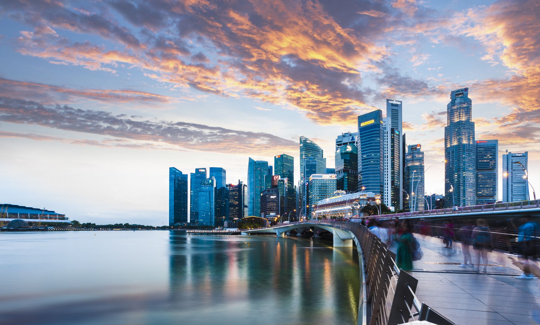 Singapore Skyline at Marina Bay at Twilight with glowing sunset illuminating the clouds