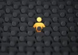 Yellow human shape among dark ones. Standing out of crowd concept