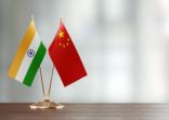 Indian And Chinese Flag Pair On A Desk Over Defocused Background