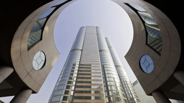 The modern business architecture of Exchange Square framing the gleaming tower of One Exchange Square, home to the Hong Kong Stock Exchange, China. ProPhoto RGB profile for maximum color fidelity and gamut.