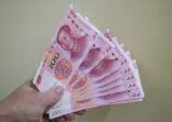 100 Chinese Renminbi banknotes in hand