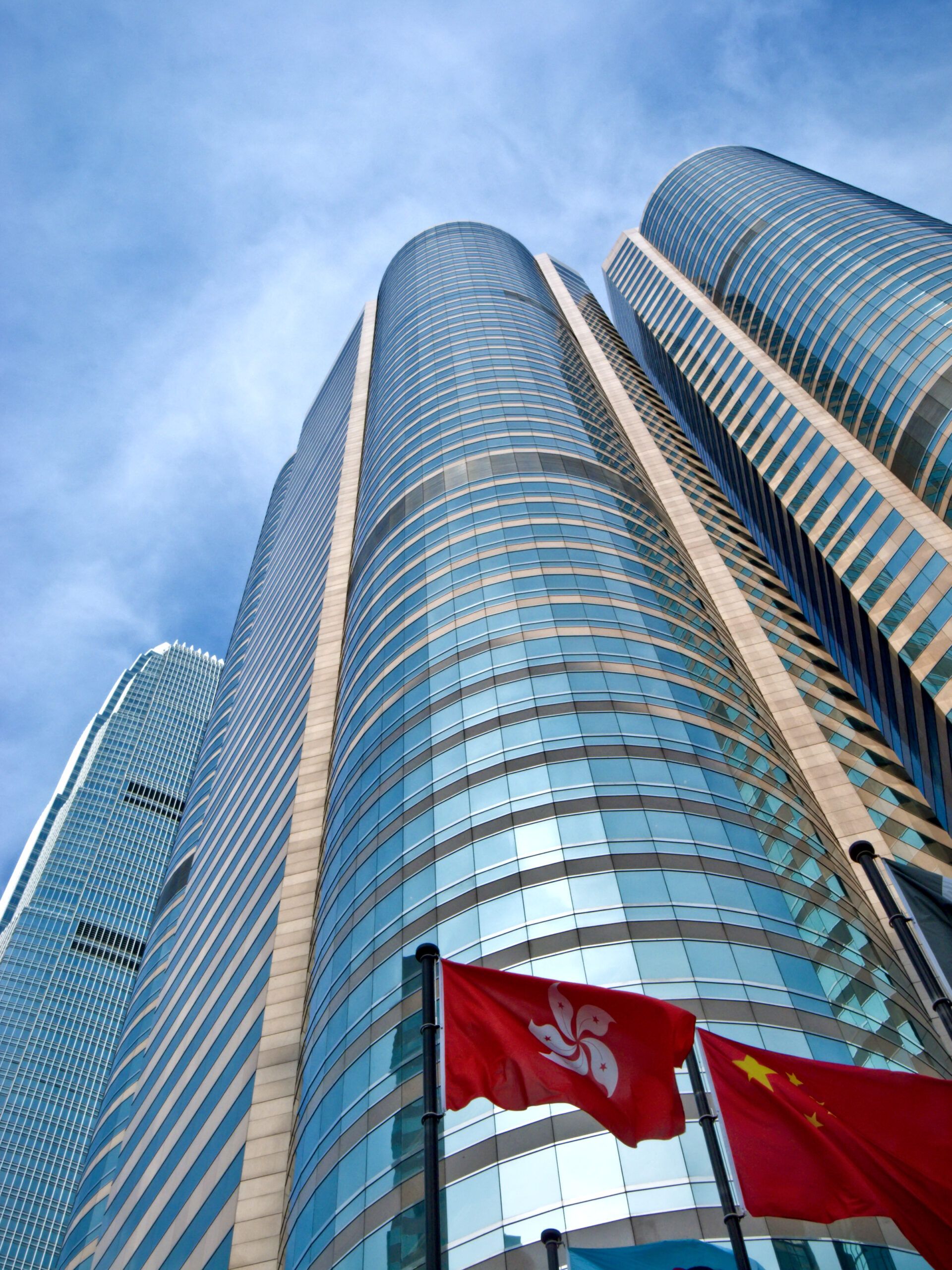 Skyscrapers in Hong Kong financial district behind Chinese and Hong Kong flags