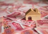 Banknote currency Chinese Yuan (CNY or RMB) and wooden house block for property and land business concept