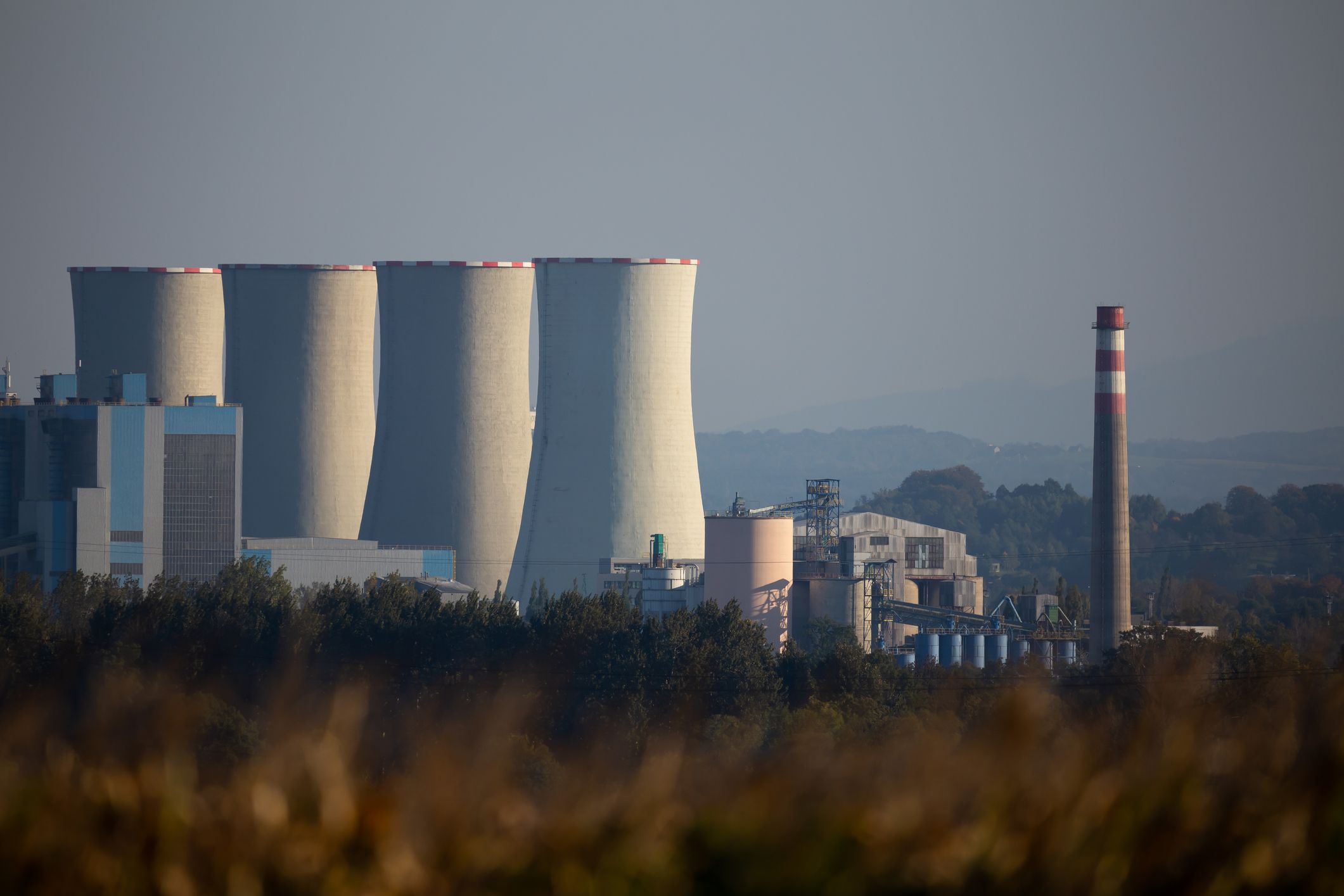 Black coal-fired power plant seen from a distance. No smoke coming out from the chimneys.