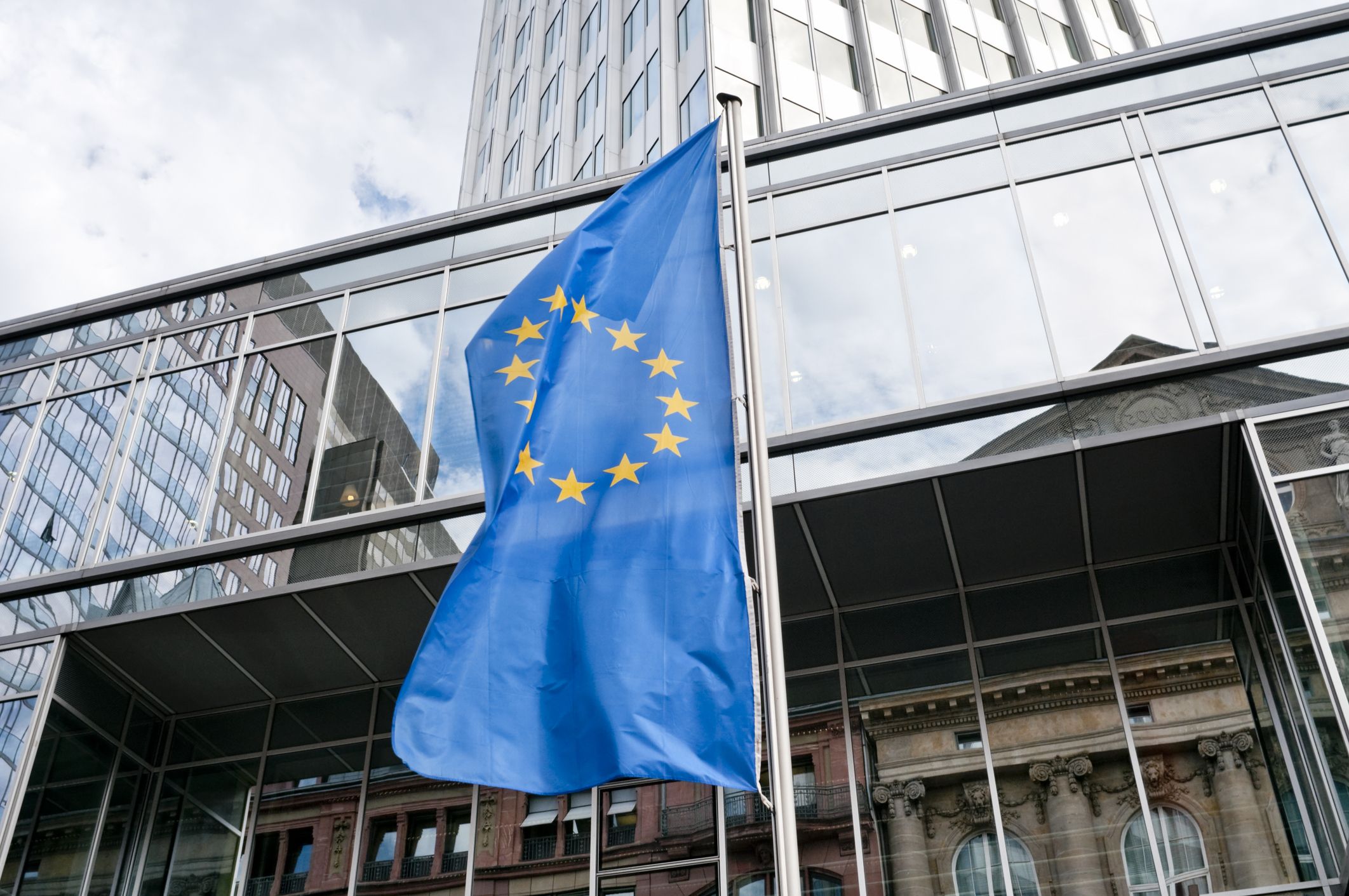 European Union flag in front of the Eurotower in Frankfurt