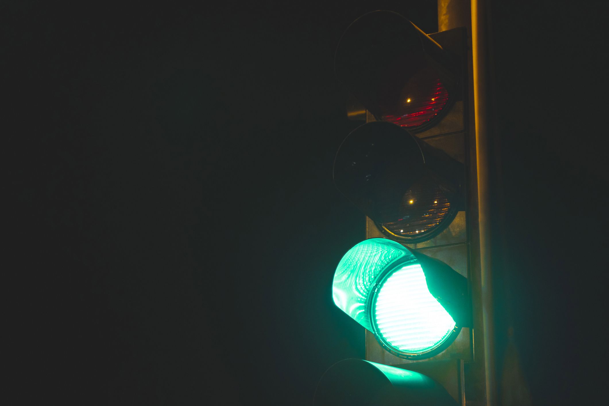 Close up traffic light with green light low angle view at night