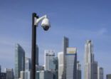 surveillance  camera in focus with Singapore CBD in background