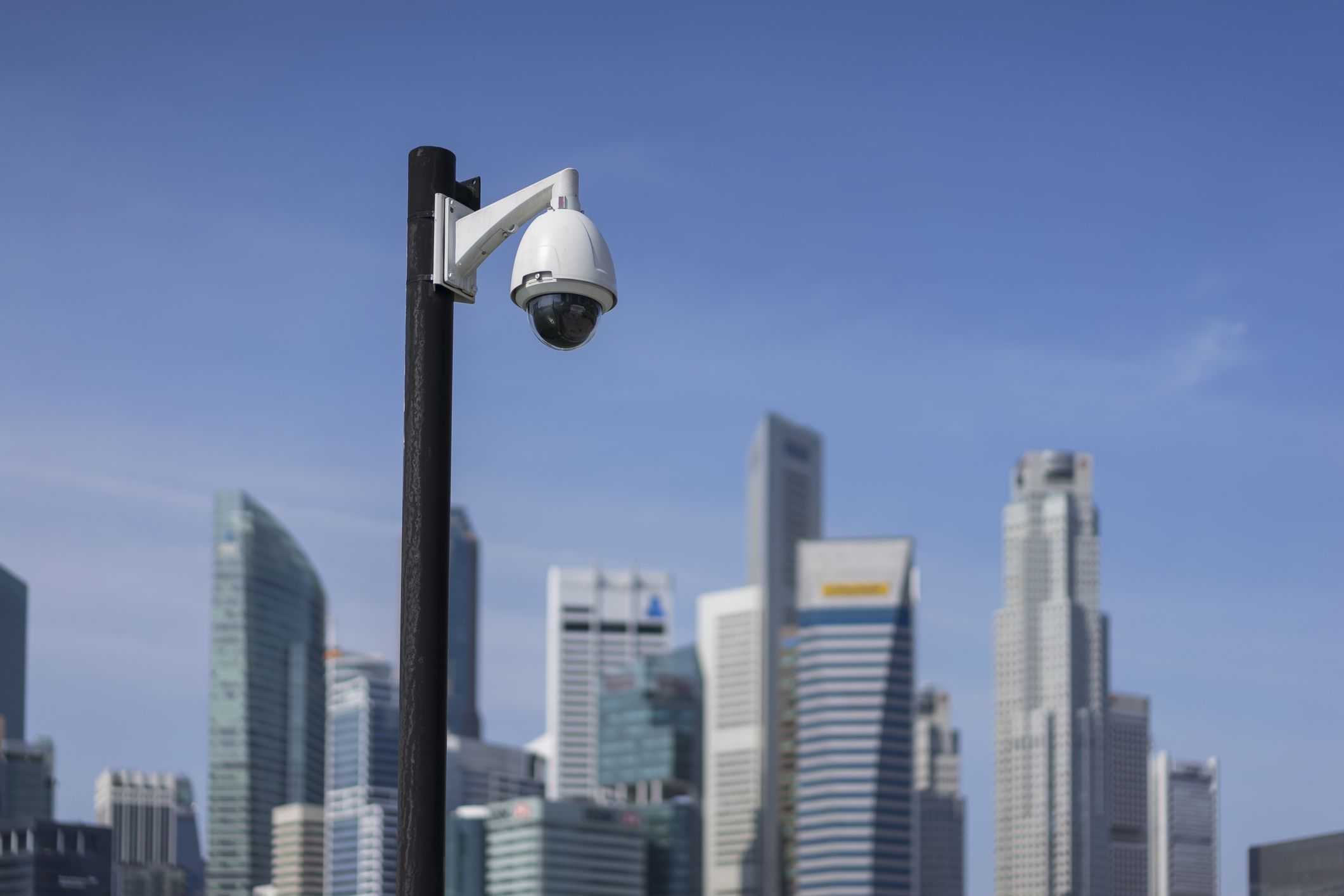 surveillance  camera in focus with Singapore CBD in background