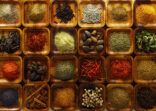 Indian spices in wooden trays.