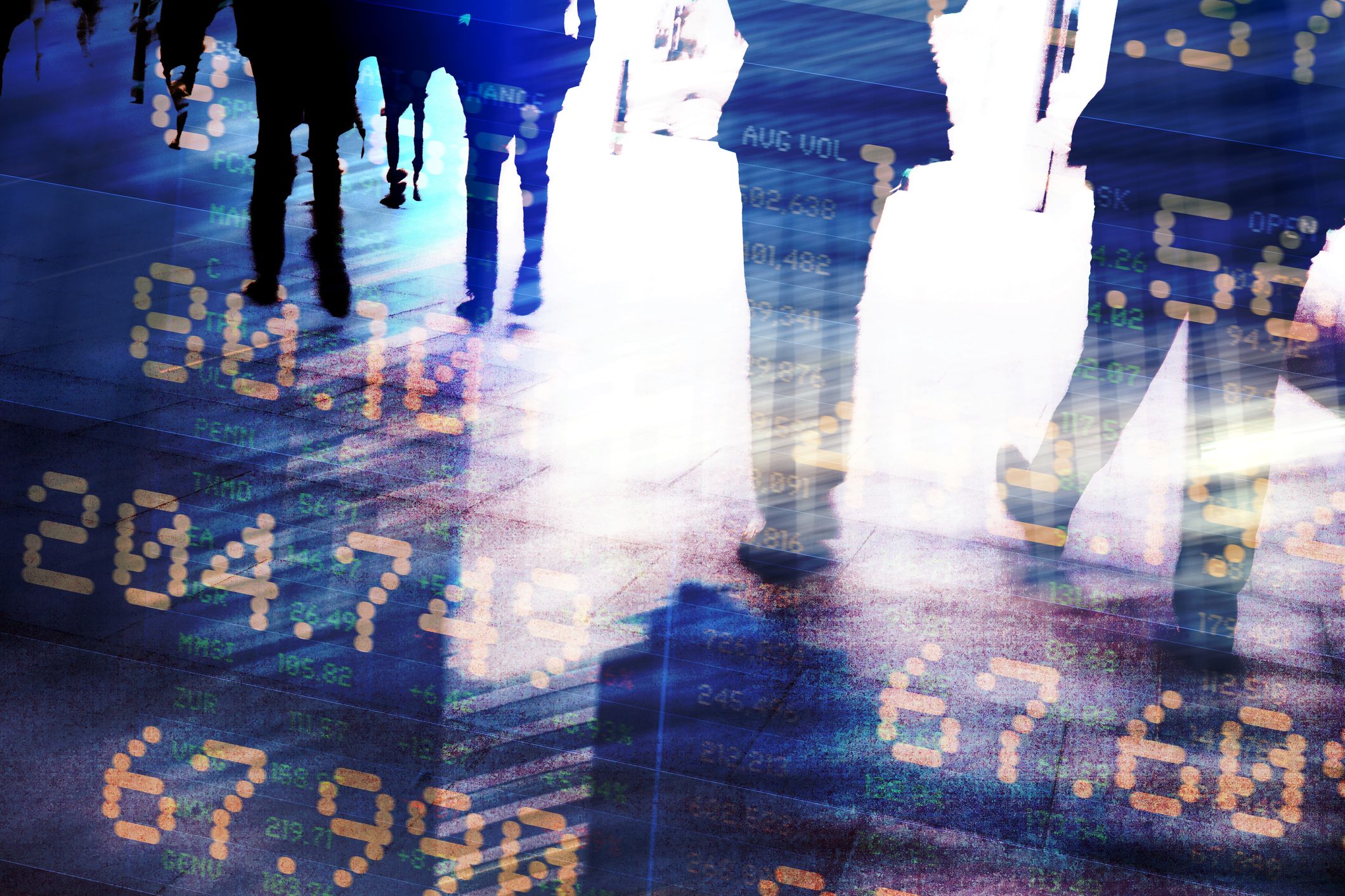 Traders in financial district with trading screen data.