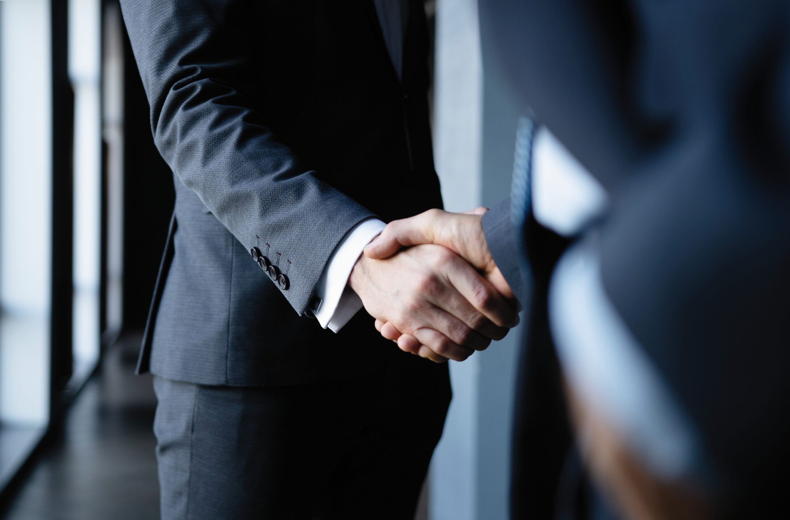 Business people shaking hands, finishing up a meeting.