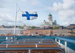 Helsinki skyline boat view with Finnish flag and Helsinki Cathedral – Helsinki, Finland