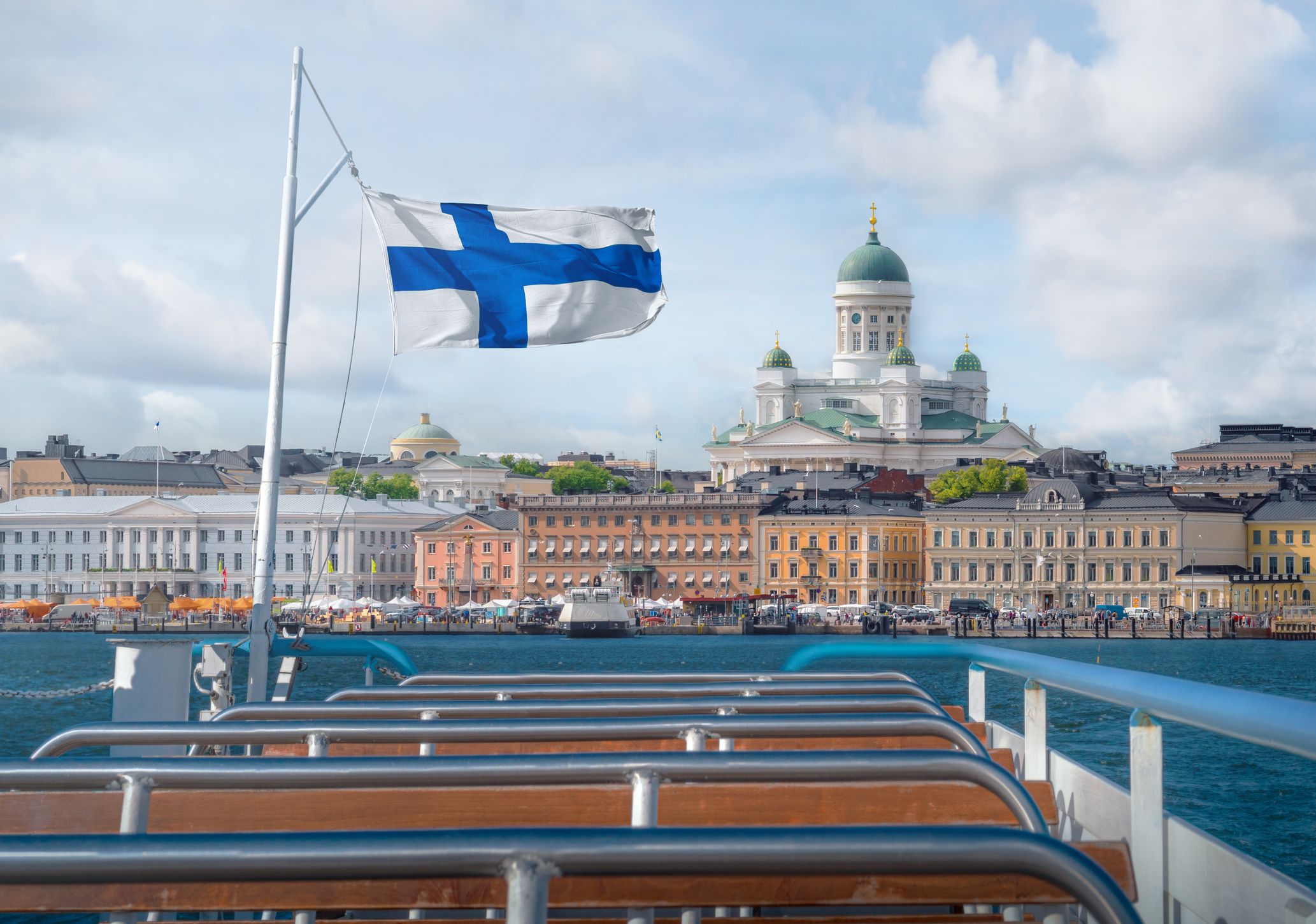 Helsinki skyline boat view with Finnish flag and Helsinki Cathedral – Helsinki, Finland