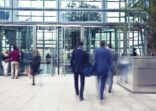 Business People Entering and Leaving Office Building, Motion Blur