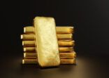 Gold bullion leaning on a stack of gold ingots. Illustration of the concept of precious metal trade and wealth