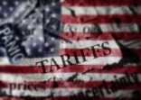 Tariffs news headlines over an American flag